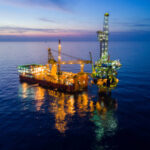 Aerial View of Tender Drilling Oil Rig (Barge Oil Rig) in The Middle of The Ocean at Sunrise Time